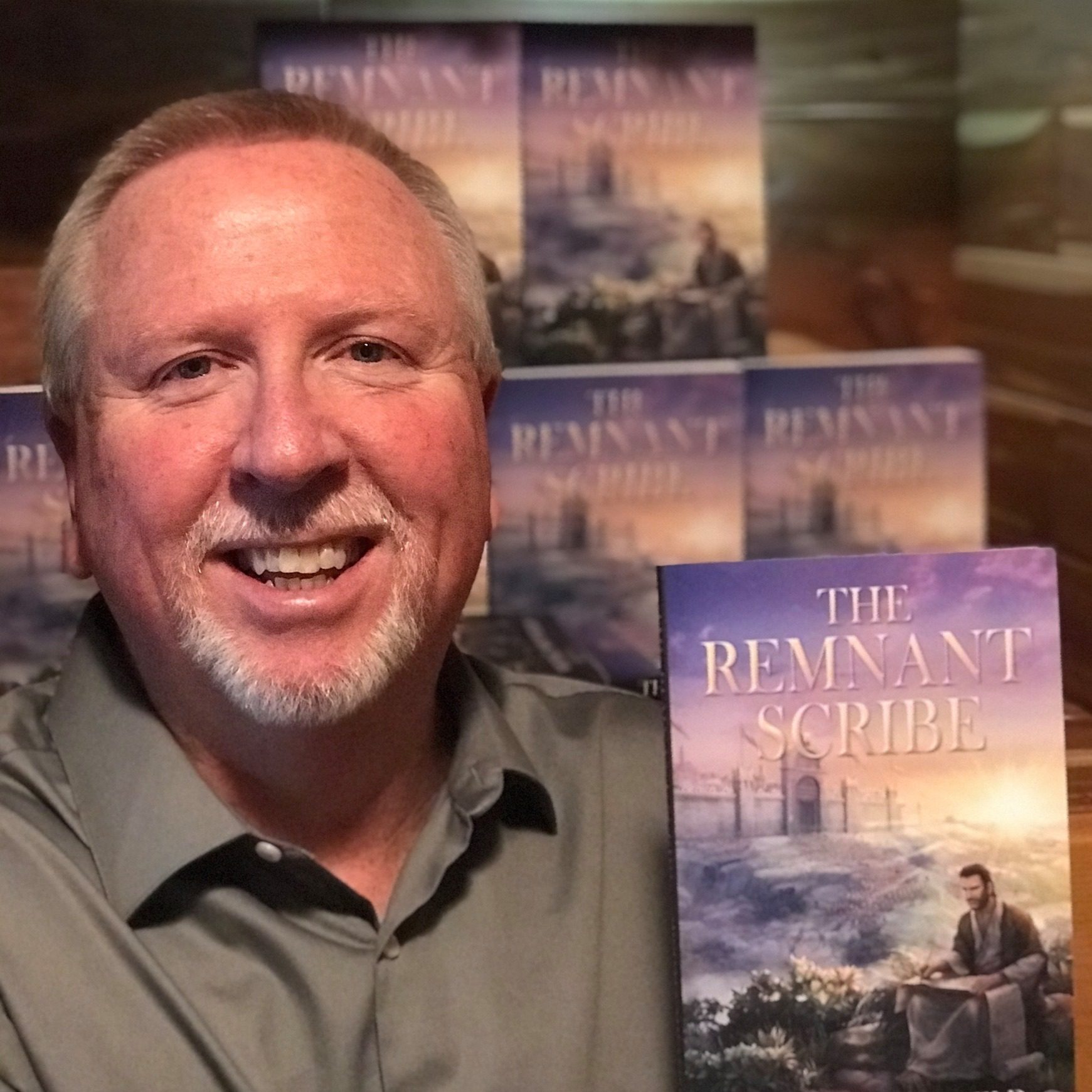 Michael Shuffield holding his first published book, The Remnant Scribe
